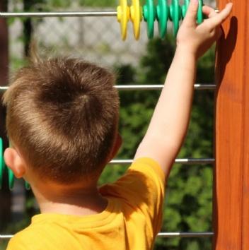 Image of infant school-age child and giant abacus